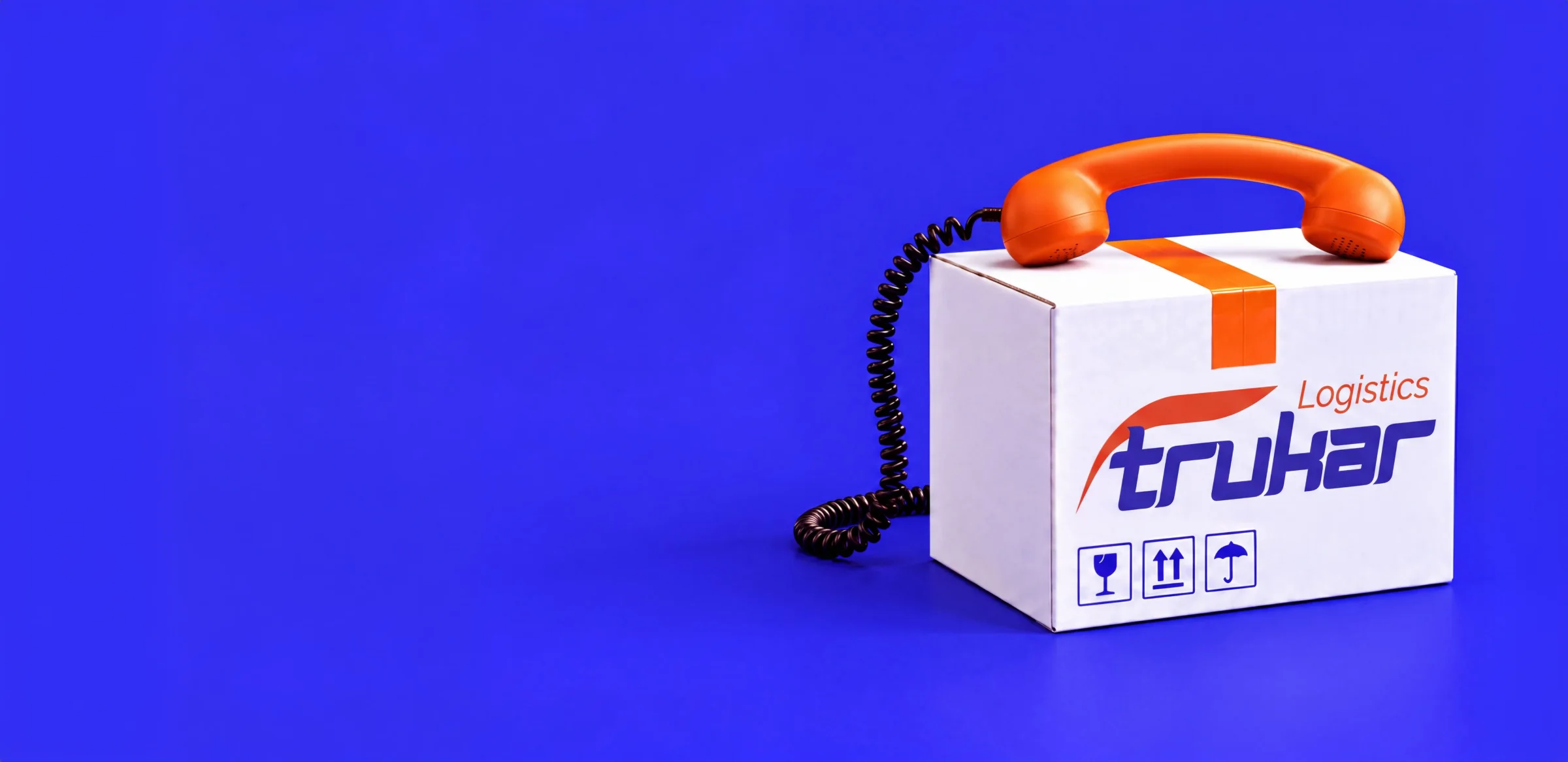 Karton mit Trukar-Logistics-Logo und einem orangefarbenen Telefonhörer darauf